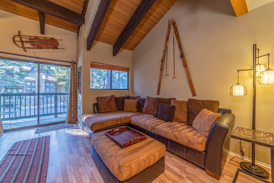 Living Room with Vaulted Ceilings and Balcony