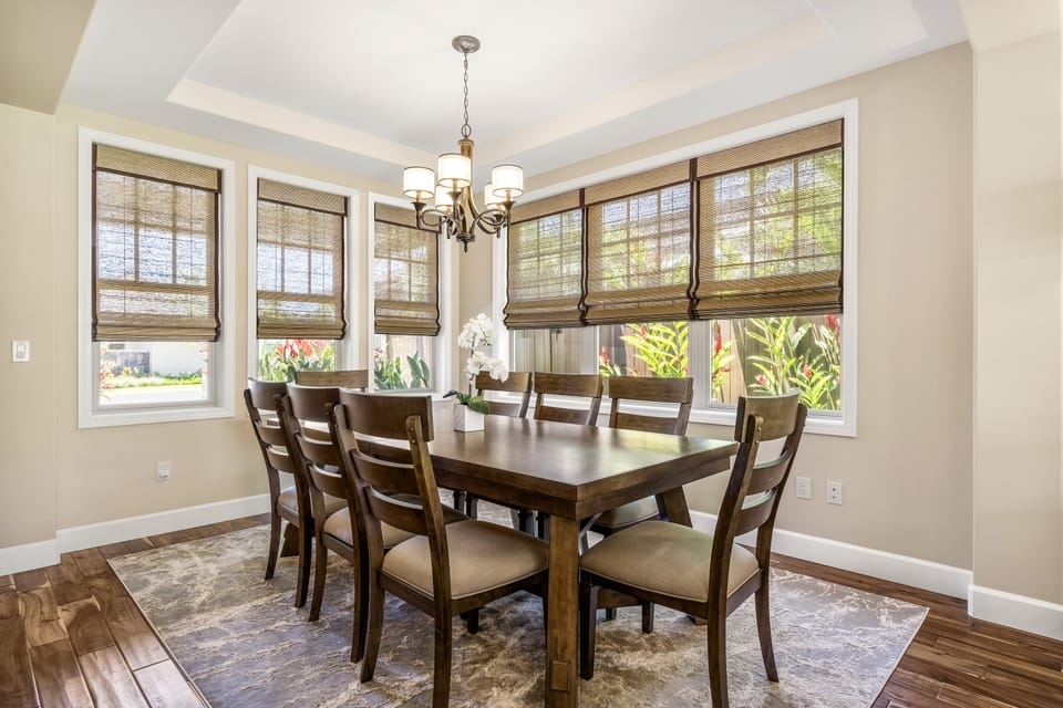 The dining area and large windows looking out onto tropical landscaping.