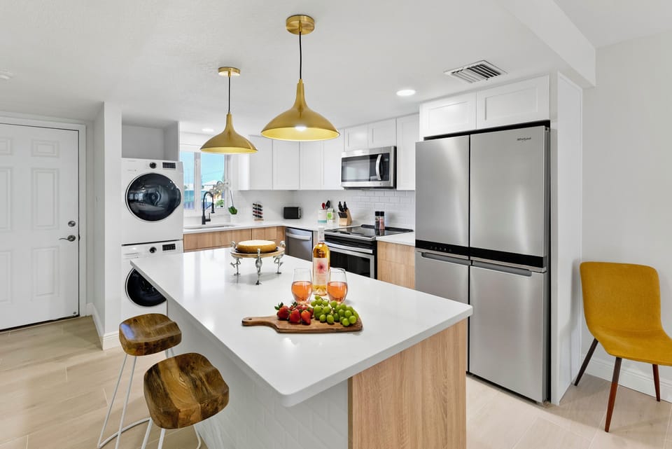Sleek modern kitchen with elegant lighting a large island and top appliances