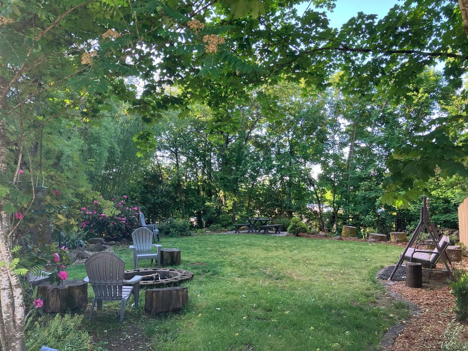 Fire pit area with picnic table, bench, and picnic table during Spring