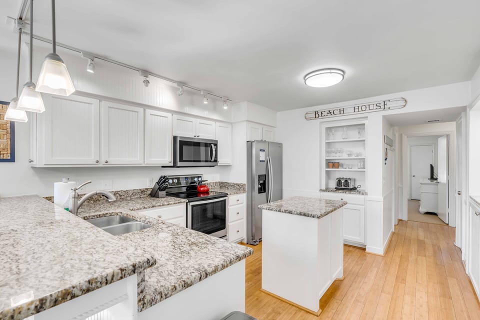 Coastal Kitchen with ample counter space and granite countertops