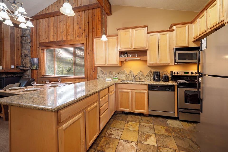 Your fully equipped kitchen features granite counters, maple cabinets, and stainless appliances—perfect for preparing memorable meals together.