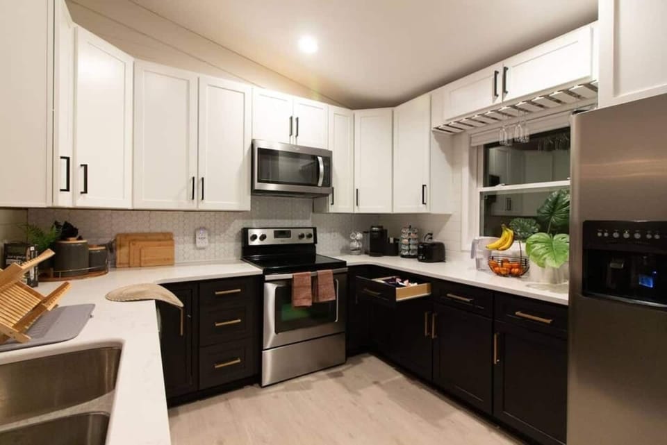 Bake pizza, lasagna, cookies, and pie with electric heat!  Enjoy the fully renovated kitchen featuring stunning quartz countertops and sleek stainless steel appliances. This kitchen is fully stocked with all the cookware, utensils, glassware, a