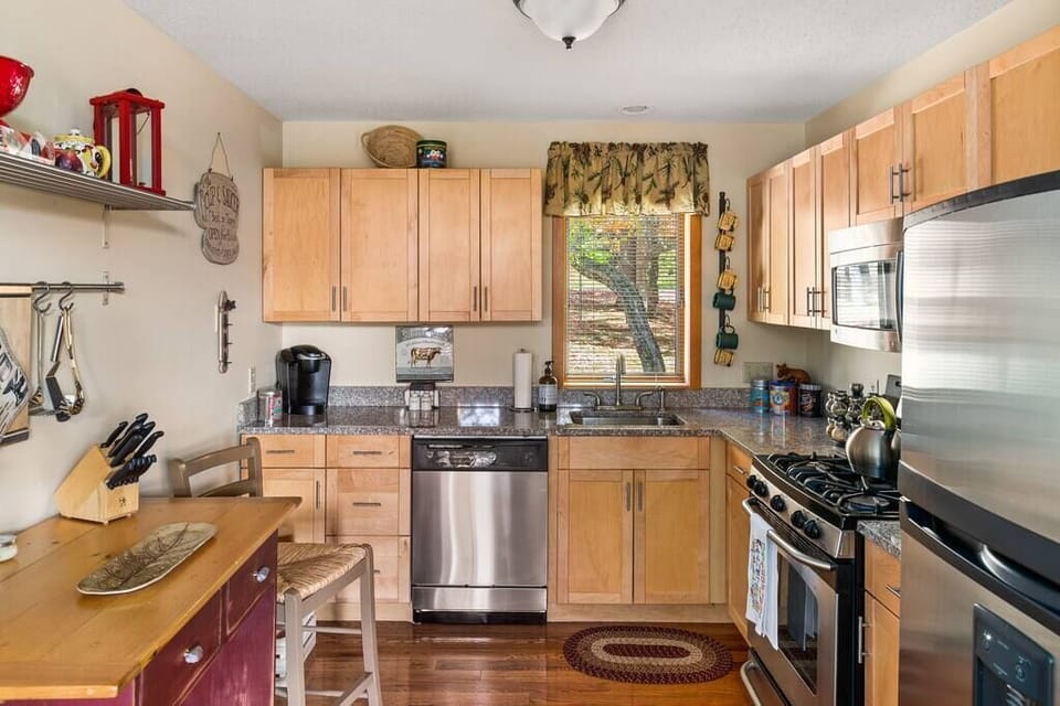 Updated kitchen with stainless steel appliances and granite countertops.