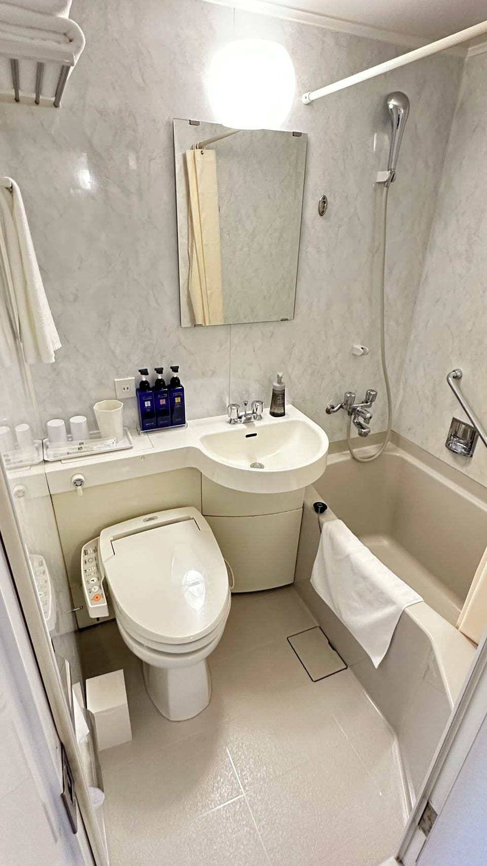 Combined shower/tub, hair dryer, slippers, electronic bidet