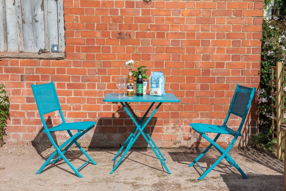 Outside The Hayloft there is a little terrace with bistro style table and chairs