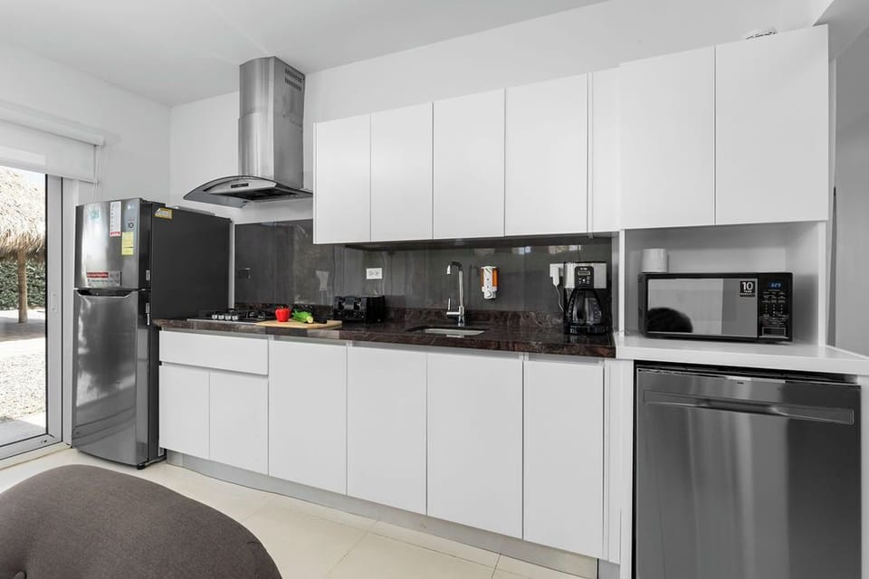 This bright and open kitchen is designed for functionality and comfort. With ample storage, sleek countertops, and all the cooking essentials, you'll feel right at home preparing meals during your stay.