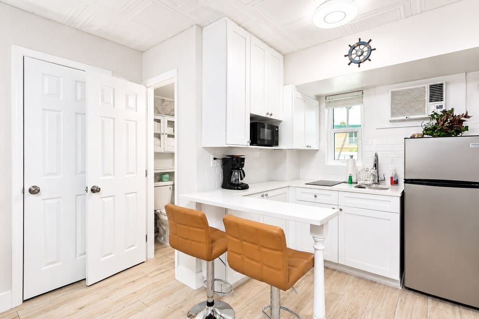 All major appliances are provided, including a full-size fridge, stovetop, and microwave, plus a toaster, drip coffee maker, and pots and pans — everything you need to cook up breakfast or beach snacks with ease.