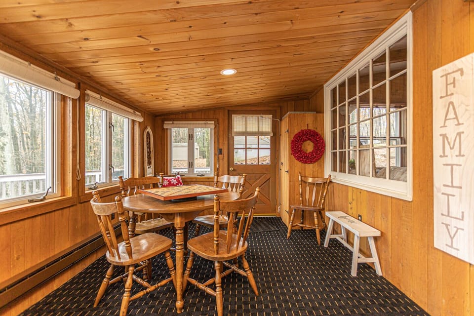 The four-season heated sunroom overlooks the stunning lake & ski slopes.