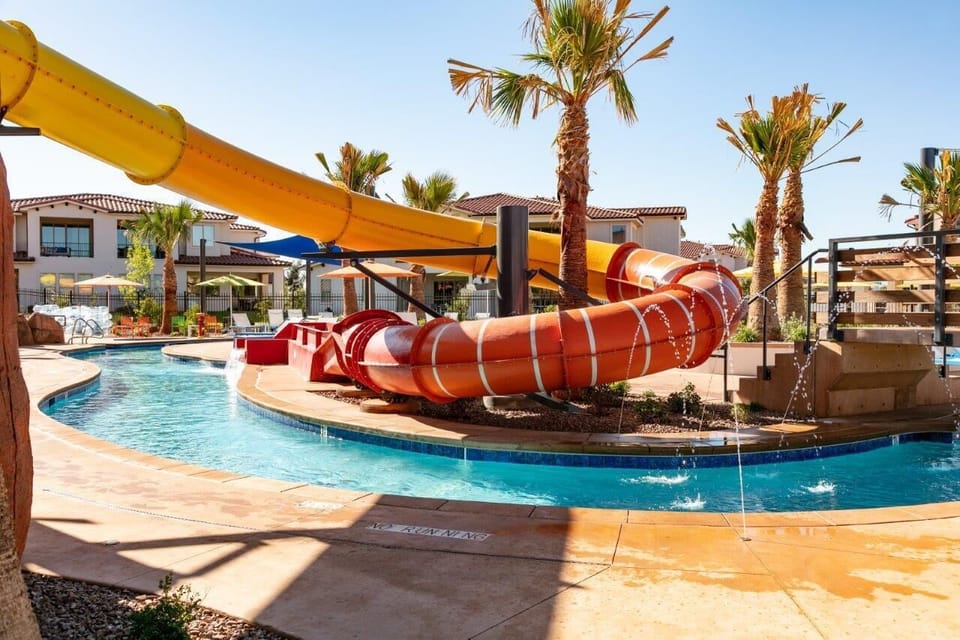 Water slide and lazy river at the resort pool just steps off the patio