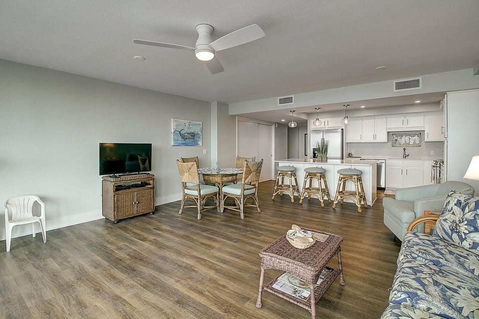 Your spacious open-plan living area flows seamlessly from cozy seating to dining and modern kitchen, perfect for relaxing evenings together.