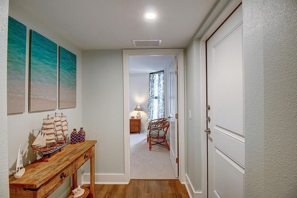 Your private hallway welcomes you with coastal charm - ocean artwork and nautical touches create a serene atmosphere leading to your peaceful retreat.