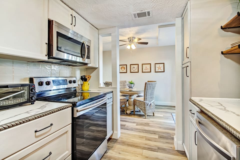 Fully Equipped Kitchen with Natural Stone Countertops and Stainless Steel Appliances