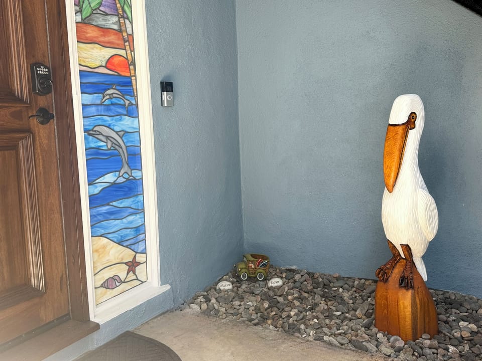 Your Home by the Sea begins with stained glass & a hand-carved pelican.