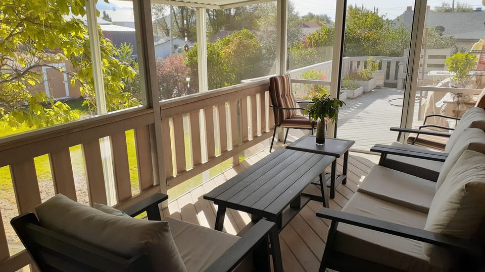 Backyard covered/screened deck and open deck.