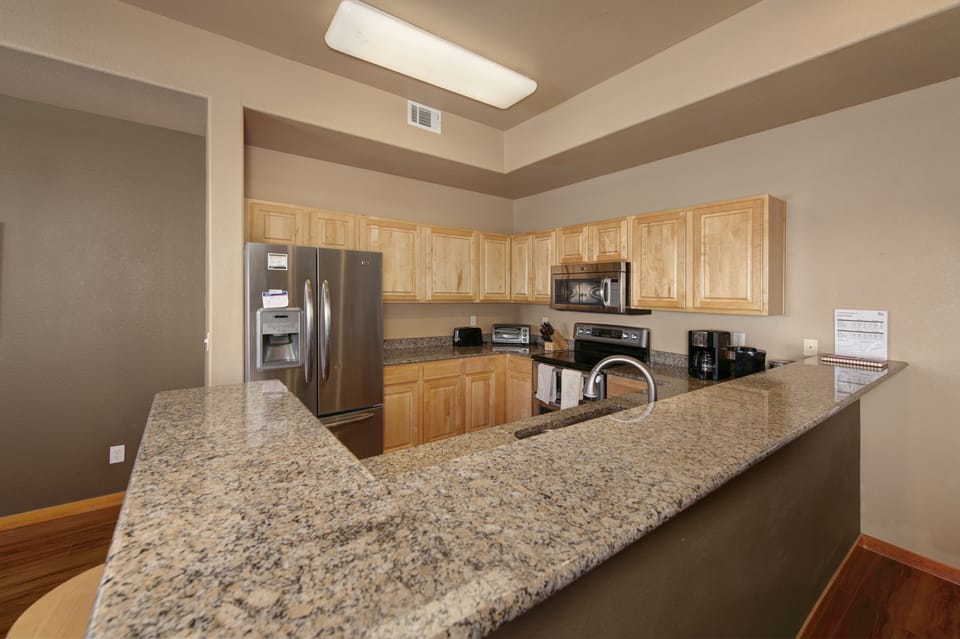 Full kitchen with stainless steel appliances on the main level.