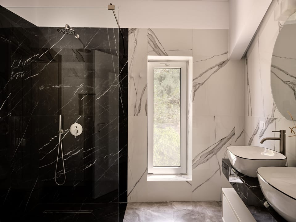 Iconic bathroom with walk in shower & double sink.