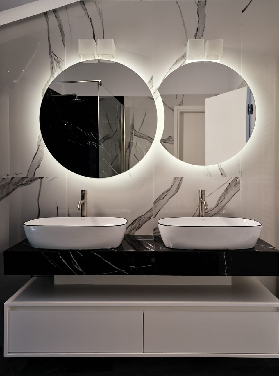 The stylish concrete bathroom includes a large rainfall shower.