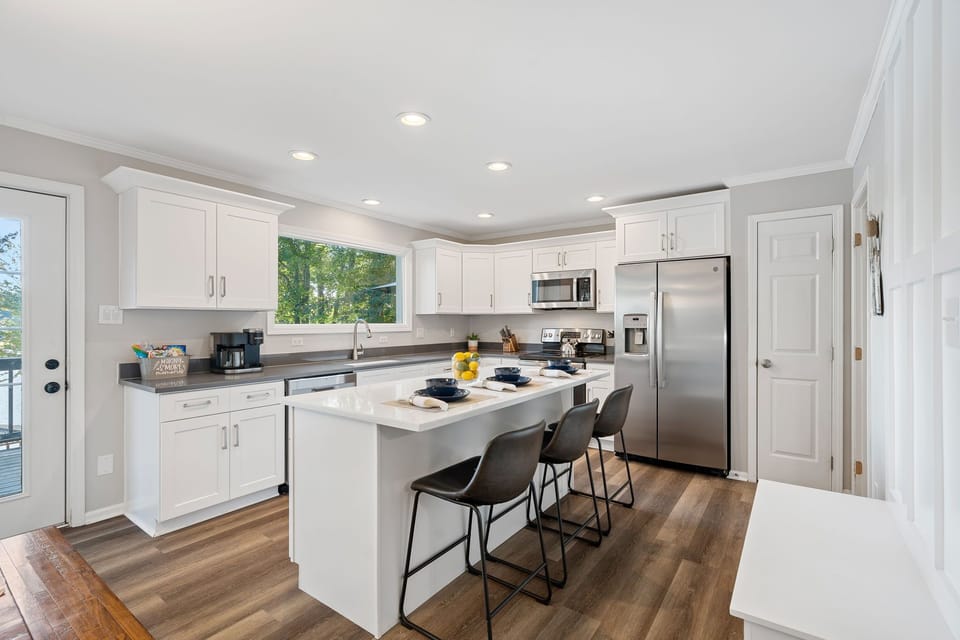 Fully stocked kitchen with island seating for 3.