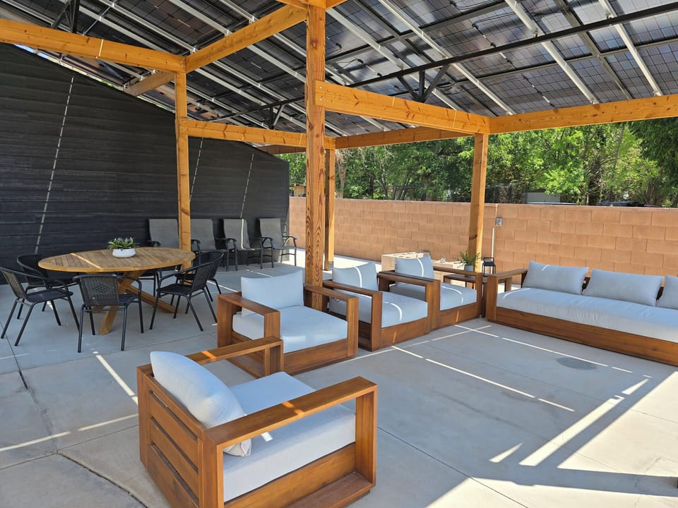 Outdoor lounge space under solar pergola
