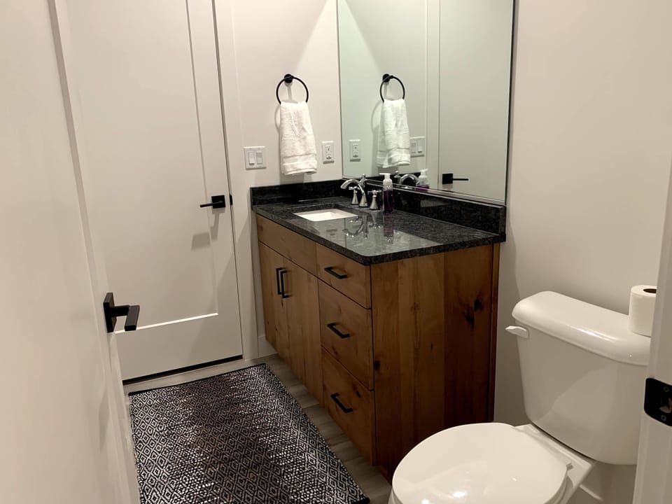 Half bath on main connected to room with two queens 