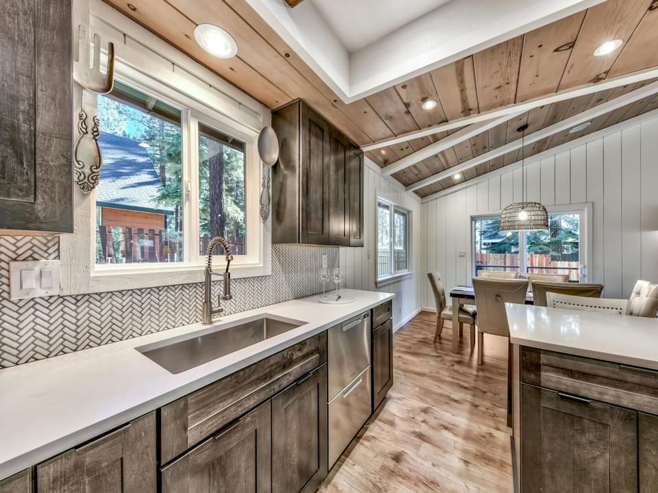 You'll love cooking in this rustic-chic kitchen with beautiful wood beams, modern appliances, and serene forest views from every window.