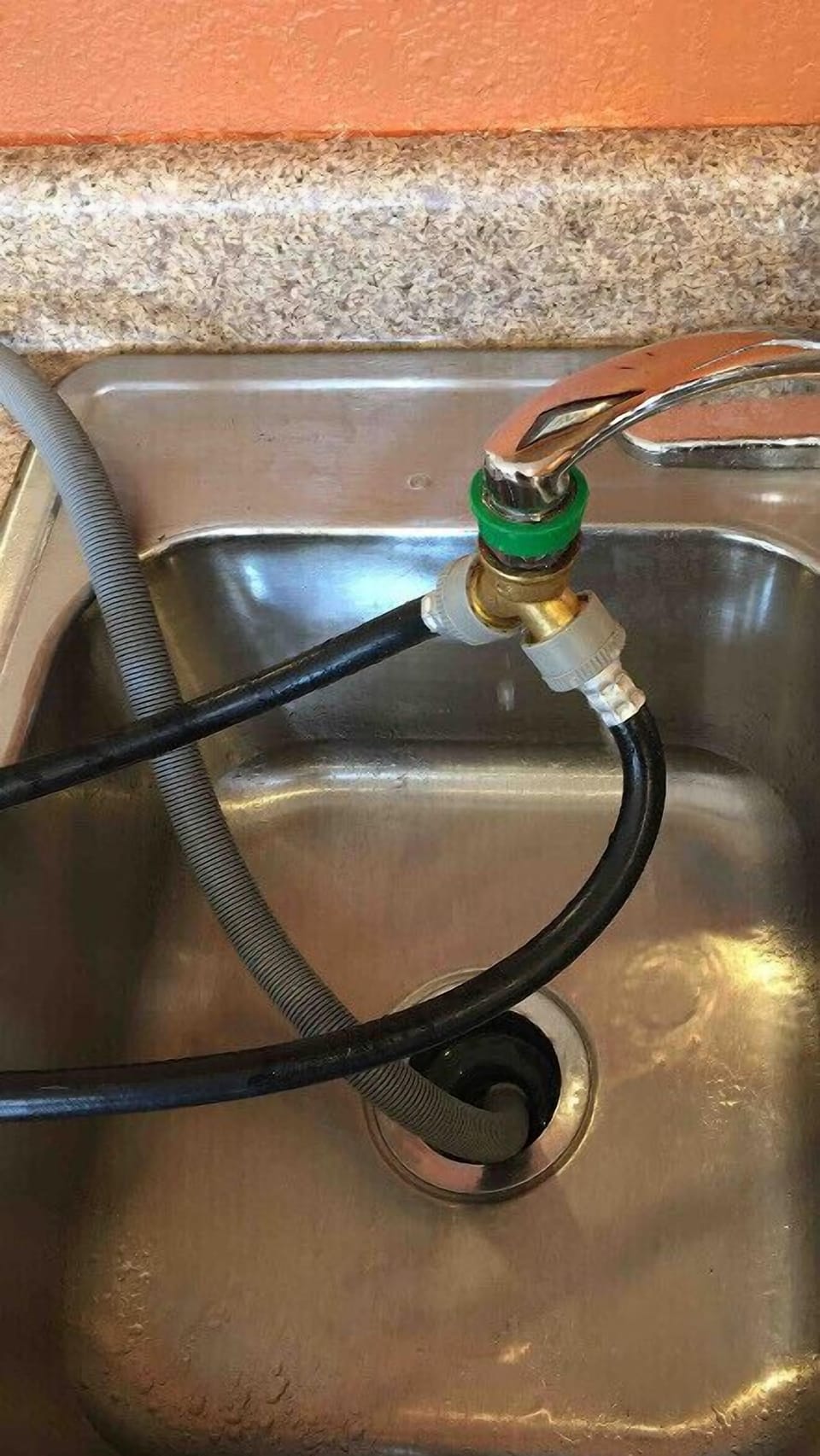 Washing machine hose attached to kitchen faucet. Manual under kitchen sink.