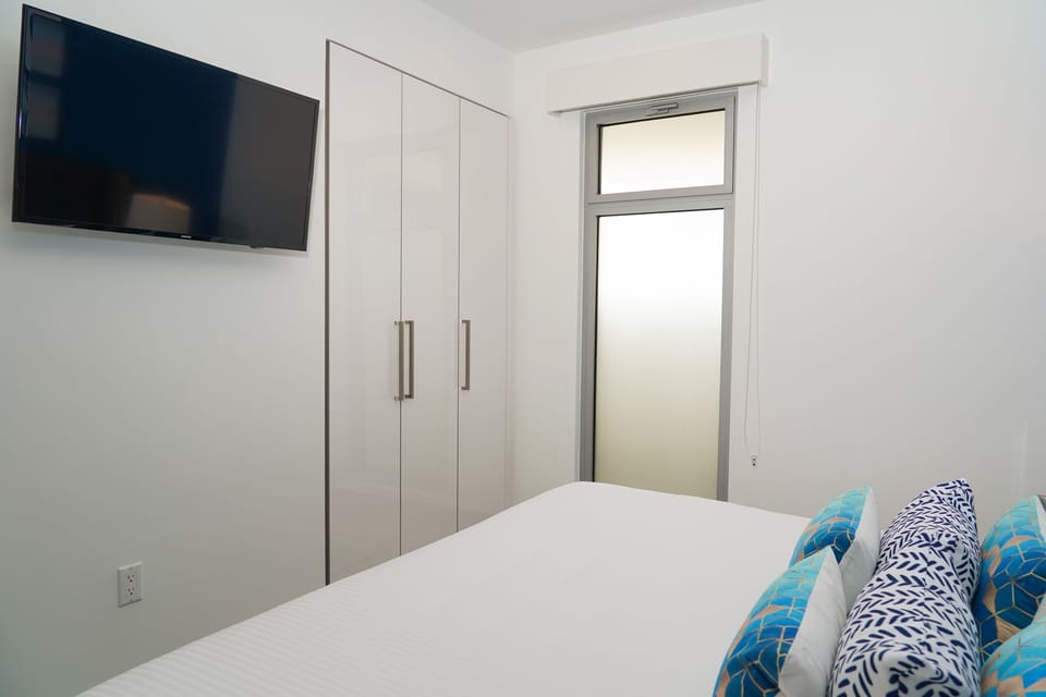 Your restful retreat awaits with a plush bed, flat-screen TV for your entertainment, and ample wardrobe space to settle in and feel right at home.