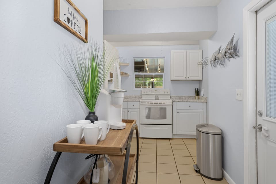 Coffee Station with Keurig Coffe machine and and assortment of coffee mugs.