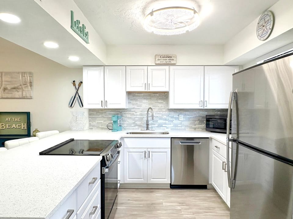 Kitchen with white cabinetry and stainless steel appliances
