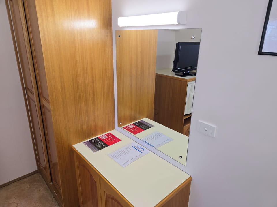 Comfort Room | Desk, laptop workspace, blackout drapes, iron/ironing board