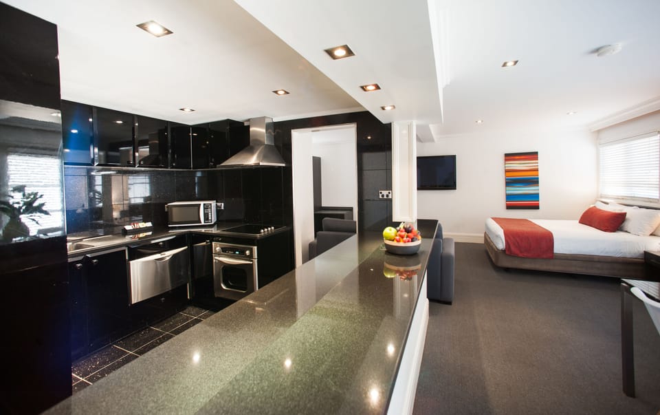 Deluxe Suite with Pool View & Kitchen | Private kitchen | Fridge, coffee/tea maker, electric kettle