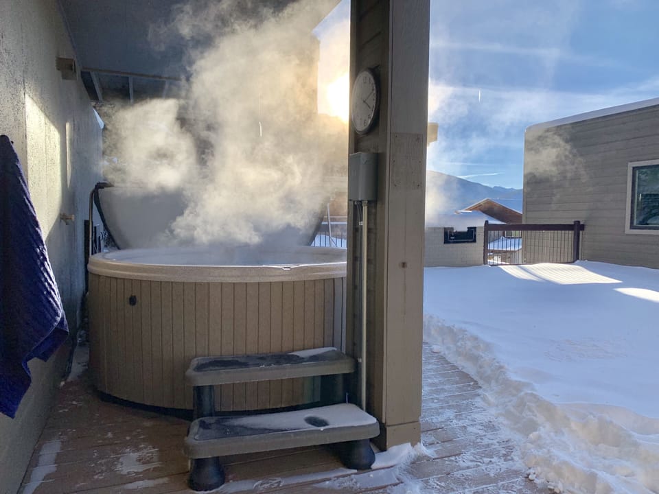 6 person common area hot tub with a covered walkway. 