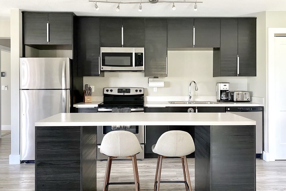 Open concept, fully equipped kitchen with bar seating for two. 