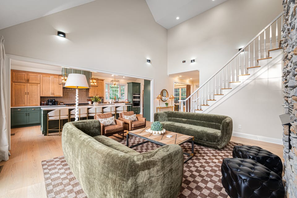 [Main Living Area] Sink into plush velvet sofas and leather armchairs designed for total group comfort.