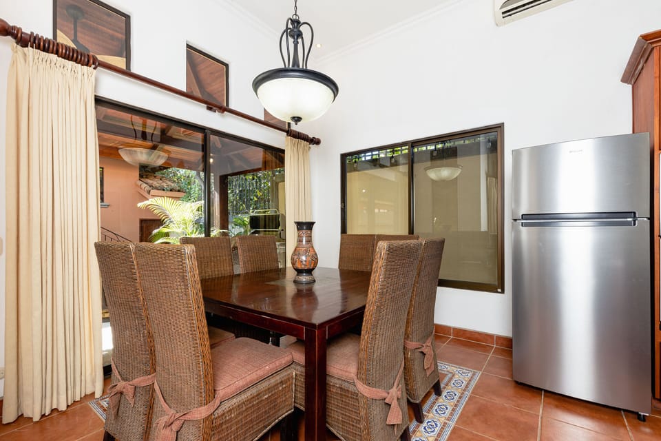 Next to the living room, there's a stylish dining area with a big table for eight people.