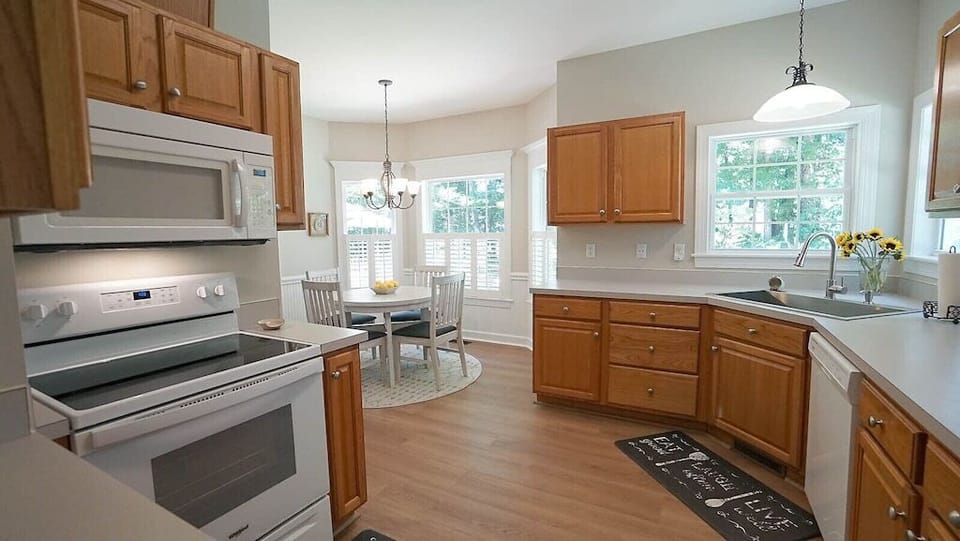 Stove, microwave and view of how light and bright the home is with all the windows