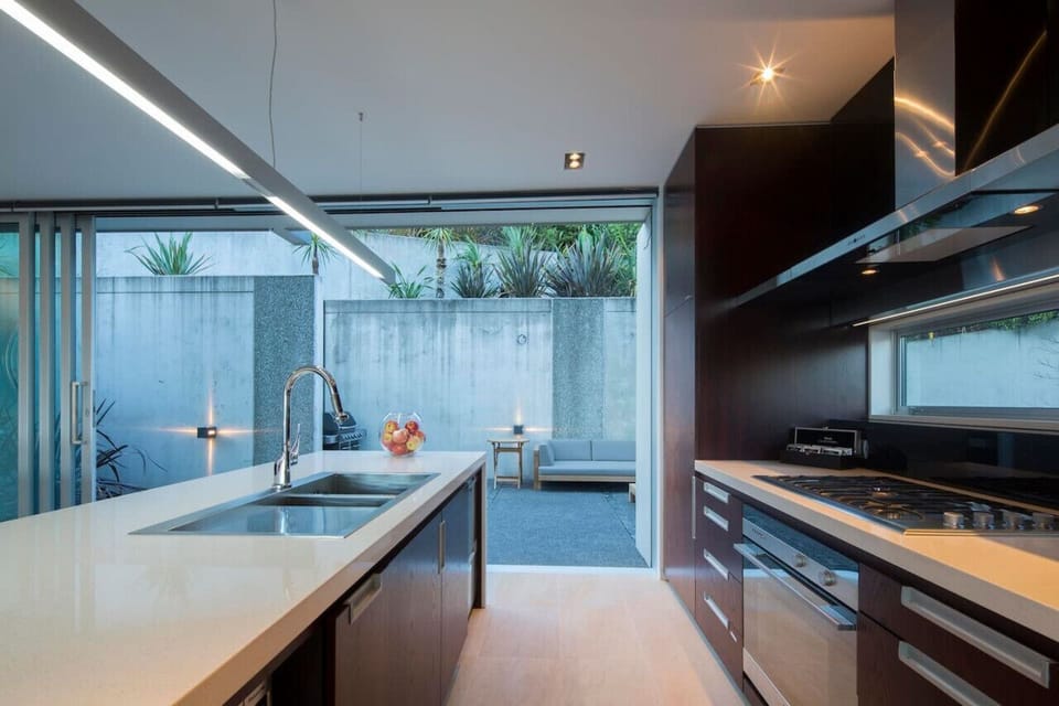 A well-equipped kitchen with gas cooktop, oven, dishwasher, coffee machine, and more.