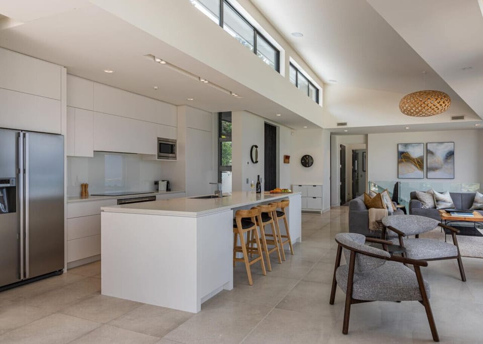 Kitchen and living area, looking towards the hallway to the office, media room and the master suite.