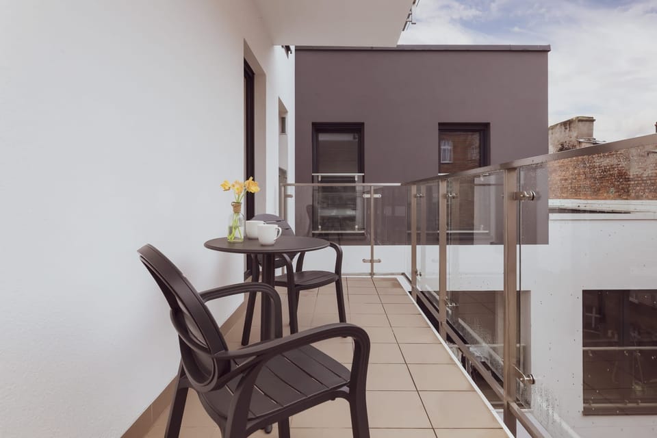A balcony space with modern furniture for relaxation.