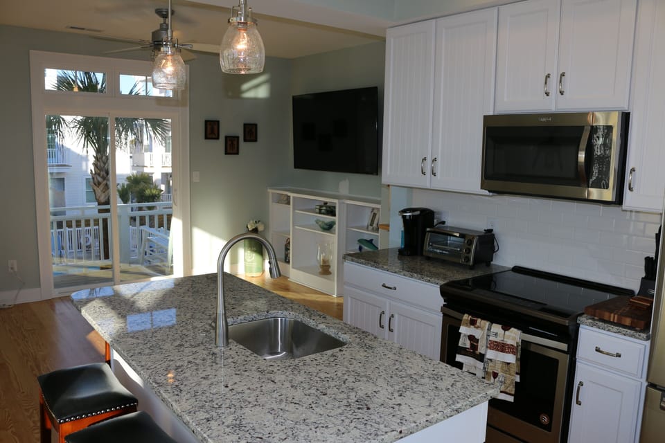 Kitchen with granite counters and stainless steel appliances.