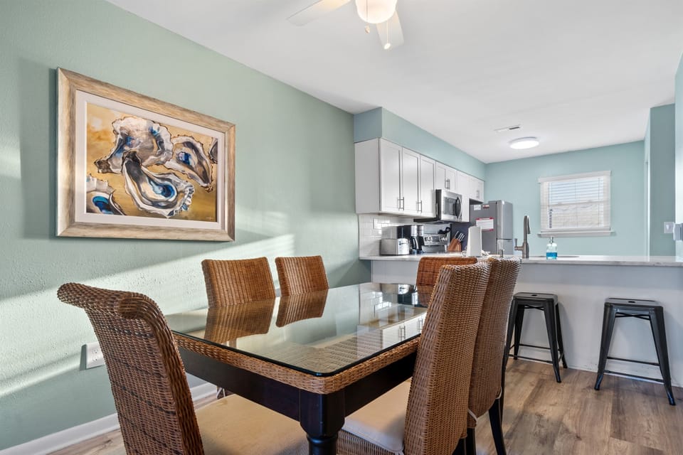 Dining area with 4 bar stools and dining table seats 6