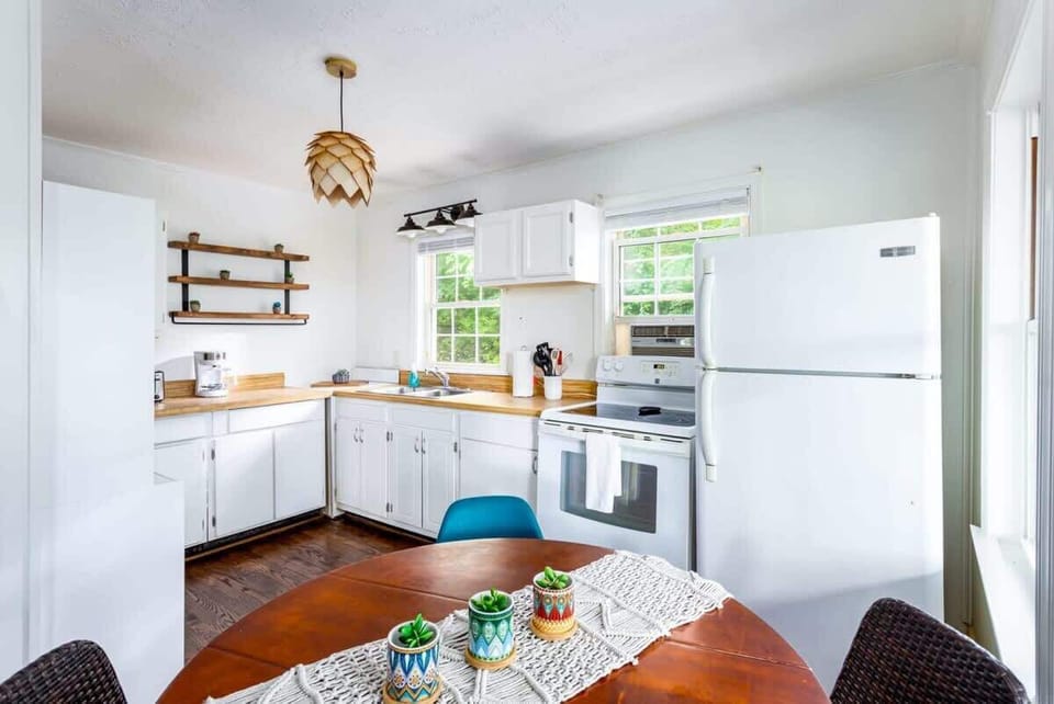 Fully stocked kitchen with microwave and oven/stove.