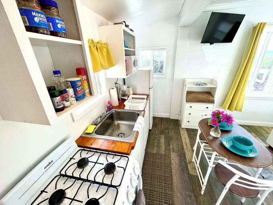 Full size kitchen for in home cooking with ocean views from kitchen window.