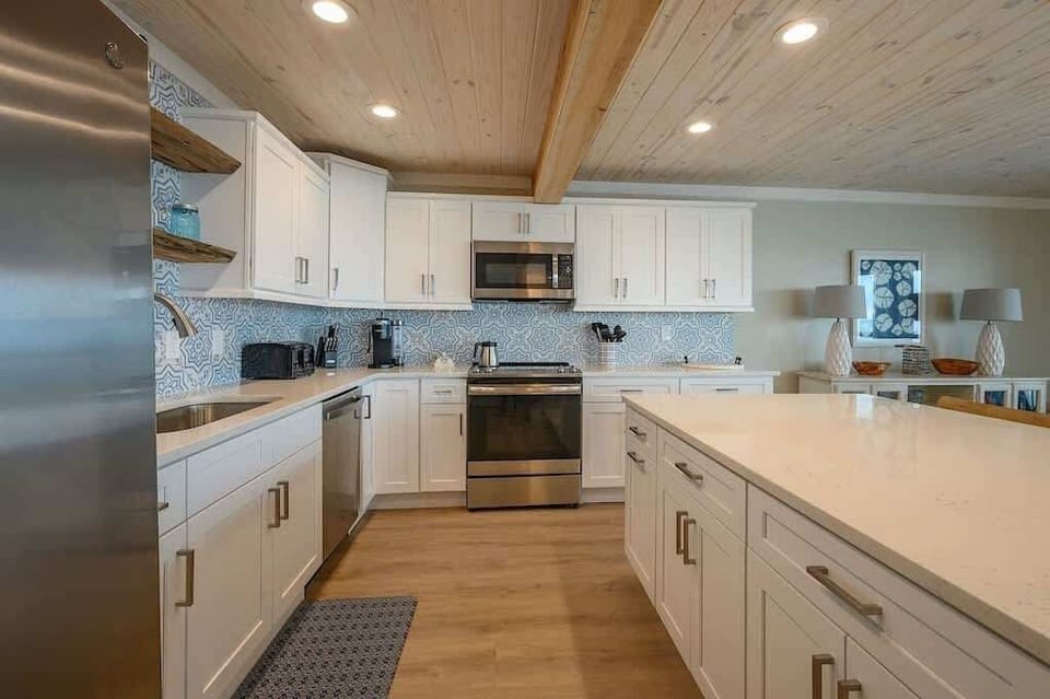 - Spacious layout gives you room to cook, prep, and move around with ease - Big island doubles as a place to gather, snack, or enjoy a laid back breakfast - Wood accents, soft ceiling lights, and tile backsplash keep things inviting