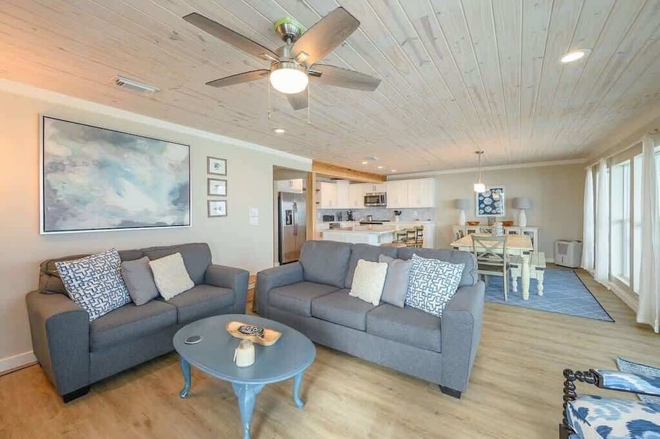 - Open concept layout blends living, dining, & kitchen for easy group time together - Dining table seats everyone comfortably for meals, games, or a morning cup of coffee - Soft tones, natural light, & wood details give it a calm & welcoming feel