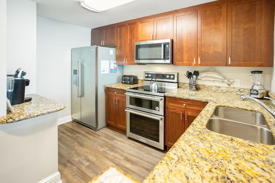 Your fully equipped kitchen features granite countertops, stainless steel appliances, and ample storage for preparing meals during your stay.