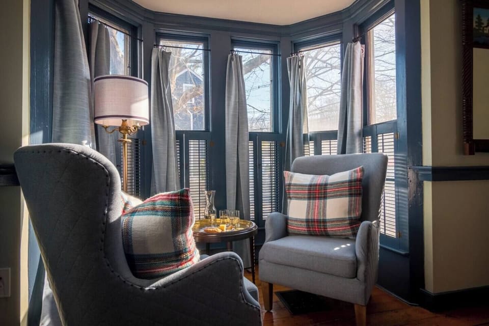 Cozy sitting area in bay window which overlooks the side yard. How romantic!