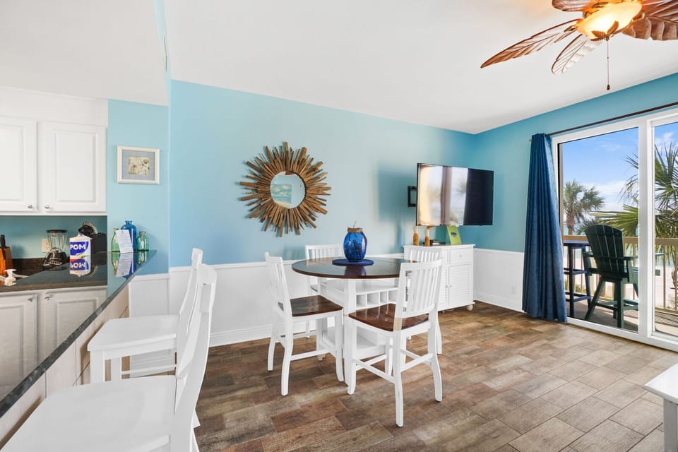 Enjoy meals in your bright coastal dining space with ocean breezes flowing through sliding doors to your private balcony.