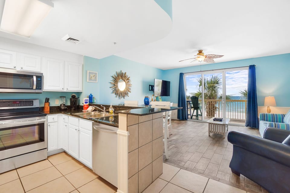 Your open-concept kitchen and living area flows seamlessly to a private balcony with stunning ocean views.